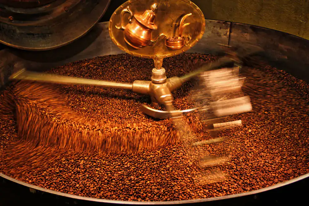 Coffee beans tumbling in a hot roaster drum